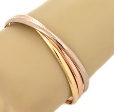 "This gorgeous authentic triple interlaced bangles are by Cartier from the Trinity Collection. They are crafted from 18k pink, white and yellow gold respectively in a fine polished finish.  each bangle is 4.5mm wide with a dome shape. They are set in a rolling style and  full designer signature with the serial number and gold content. Comes with Cartier polish authentication paper  Brand:  Cartier Hallmark:   Cartier 750 GD 1997 M0099 Material: 18k yellow, pink and white gold Measurement:  7.75\ Tiffany Watches, Gold Bangle Bracelets, Bracelets Vintage, Hammered Gold, Gold Band Ring, 18k Yellow Gold Ring, Wide Band Rings, Gold Bangle Bracelet, Gold Bangle