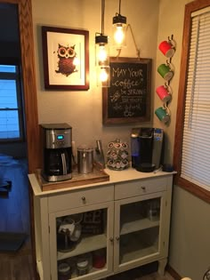 a coffee bar with an assortment of items on the counter and framed pictures above it