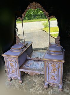 an antique vanity with mirror and drawers on the ground