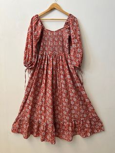 "Women's cotton dress, bohemian smocked long dress, Indian cotton maxi, hand block print cotton gown, ruffle sleeves floral long dress, hippie dresses, cotton maxi, long maxi, comfortable dress, smocking maxi dress, ruffle dresses, summer dresses, floral dress, boho dresses, vintage gown Feel beautiful and confident throughout your days wearing our block printed outfits, made with high quality soft and breathable cotton fabric.  The print on the dress is known as \"BLOCK PRINT\" which is centuries old technique of Indian textile carried out  by local artisans of Jaipur (INDIA) MEASUREMENTS (in inches): Size XXS-: Bust- 34″ | Shoulder- 13.5″ | Length- 51″ Size XS-: Bust- 36″ | Shoulder- 14″ | Length- 51″ Size S-: Bust- 38″ | Shoulder- 14.5″ | Length- 51″ Size M-: Bust- 40″ | Shoulder- 15″ | Bohemian Flowy Maxi Dress With Smocked Cuffs, Flowy Bohemian Maxi Dress With Smocked Cuffs, Bohemian Dresses With Smocked Bodice For Gatherings, Peasant Cotton Dress With Smocked Cuffs, Cotton Maxi Smocked Dress With Ruffles, Bohemian Dresses With Smocked Cuffs, Bohemian Cotton Dress With Smocked Cuffs, Bohemian Flowy Smocked Dress With Floral Print, Bohemian Maxi Smocked Dress With Smocked Back