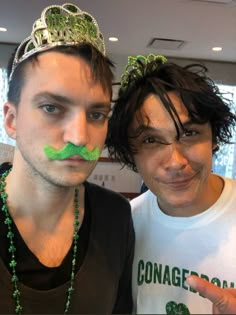 two men with fake moustaches on their faces are posing for the camera