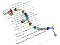 a bracelet with charms on it sitting on top of a piece of paper that says the life of jesus