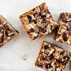 four pieces of dessert sitting on top of a white countertop next to each other