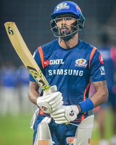 a man holding a bat and wearing a helmet