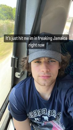 a man sitting in the back seat of a car with a hat on his head