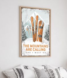 a poster hanging on the wall above a bed in a room with white walls and pillows