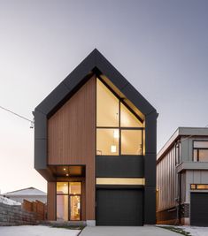 a modern house with two garages in the front and one on the other side