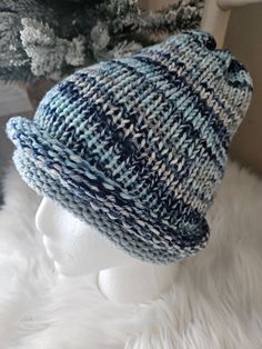 a knitted hat sitting on top of a white mannequin's head