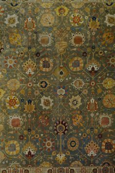 an old rug with many different designs on it