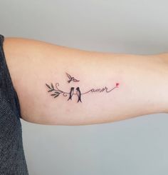 a woman's arm with two birds on it and the word love is written in cursive writing