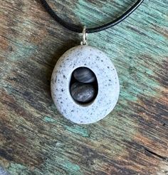 Beach stone with two stones inside.  Beach stones found on the coast of Maine. Sterling silver jump ring is welded. Beach Stones Jewelry, Jewelry Beach, Beach Stones, The Coast, Jump Rings, Stone Necklace, Stone Jewelry, Pendant Necklaces, Favorite Jewelry