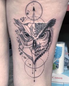 an owl tattoo on the side of a woman's thigh, with geometric shapes