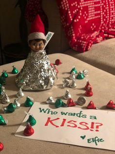 an elf is sitting on the table with hers kisses