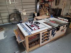 a workbench with tools and other items sitting on top of it in a garage