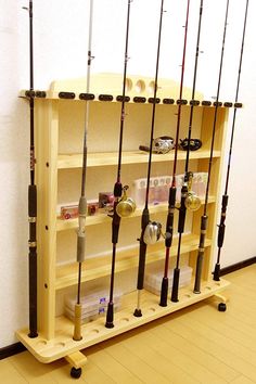 there are many fishing rods on the shelf