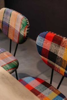 two multicolored chairs sitting next to each other