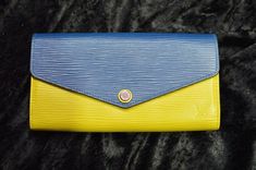 A ladies vintage Louis Vuitton Sarah wallet done in blue and gold epi.  The wallet was made in 2014, is in "AA" condition, and has a certificate of authenticity. Gold Louis Vuitton, Louis Vuitton Sarah Wallet, Cinderella Carriage, Rose Gold Morganite, White Crystals, Louis Vuitton Wallet, Vintage Louis Vuitton, Blue And Gold, Life Savers