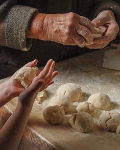 an older person and child reaching for mushrooms on a table