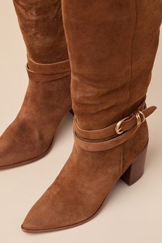 All your most exceptionally stylish fall looks are definitely going to include the Dolce Vita Tyrone Wide Calf Brown Suede Buckle Pointed-Toe Knee-High Boots! These genuine suede leather boots have a chic pointed-toe upper that rises to a 14"" knee-high with a 16.75"" circumference, an elastic gusset at the instep, and a curved topline. 8.5"" zipper at the instep. An adjustable buckle strap wraps around the ankle for a unique finishing touch! 3. 25" stacked block heel. Lightly cushioned insole. Rubber sole has nonskid markings. Genuine Suede Leather Upper. Man Made Materials. Imported. Lulus | Tyrone Wide Calf Brown Suede Buckle Pointed-Toe Knee-High High Heel Boots | Size 9.5WC. Brown Suede Knee-high Boots With Pointed Toe, Brown Suede Wide Calf Knee-high Boots, Fitted Brown Suede Mid-calf Boots, Brown Suede Knee-high Boots, Brown Suede Knee-high Boots With Snip Toe, Suede Leather Boots, Wide Calf, Brown Suede, Suede Boots