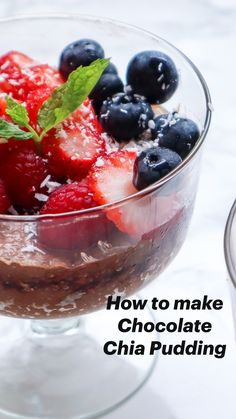 a glass bowl filled with chocolate chia pudding and berries