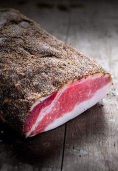 a piece of meat sitting on top of a wooden table