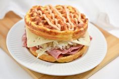 a waffle sandwich with ham and cheese on a plate