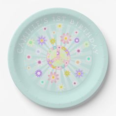 a blue plate with flowers and the words candles 1st birthday on it's side