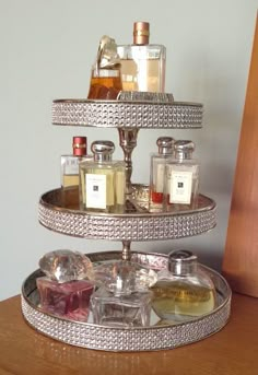 three tiered tray with perfume bottles on it