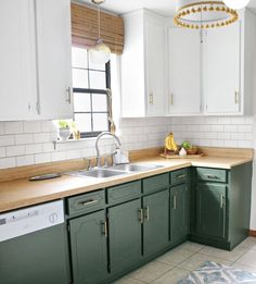 a kitchen with green cabinets and white walls