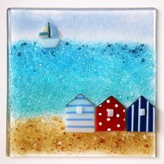 a glass tile with beach huts and a boat in the ocean