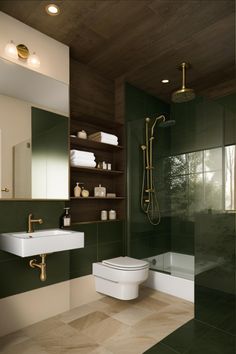 a bathroom with green walls and tile flooring, along with a white toilet sitting next to a walk in shower