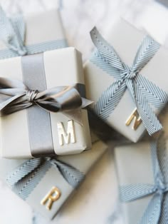 two wrapped presents with the letter m on them