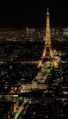 the eiffel tower lit up at night in paris, france with all its lights on