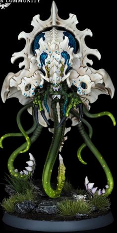 a white and green statue with an octopus on it's head, in front of a black background