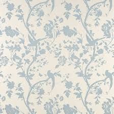 a blue and white wallpaper with flowers on it