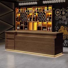 an empty bar with wine bottles on the shelves and lights in the back ground,