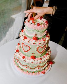 a large multi layer cake sitting on top of a white table