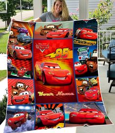 a woman holding up a blanket with cars on it