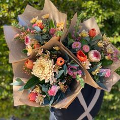 a bouquet of flowers is wrapped in brown paper