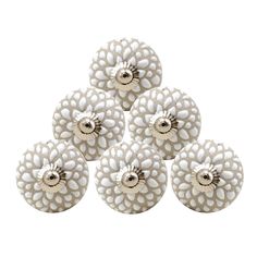 six white ceramic knobs with flowers on them