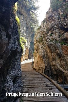 a wooden walkway in the middle of a canyon