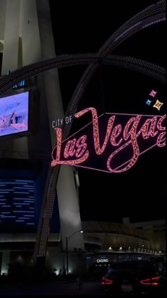 the las vegas sign is lit up at night