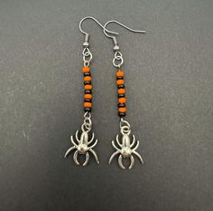 Embrace the spooky season with these Halloween dangling earrings that capture the essence of the holiday perfectly. Adorned with intricately designed spiders, each earring tells a whimsical tale of Halloween folklore. The lightweight yet eye-catching design ensures comfort while making a bold statement. Whether you're dressing up for a costume party or simply adding a touch of Halloween spirit to your ensemble, these earrings are the ideal accessory. Let these festive earrings be your playful co Halloween Folklore, Tales Of Halloween, Festive Earrings, Earrings Halloween, Gothic Earrings, Halloween Spirit, Halloween Accessories, Halloween Jewelry