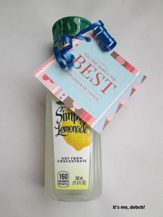 a bottle of lemonade with a blue ribbon around it and a tag on top