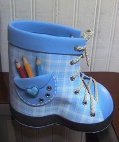 a pair of blue boots sitting on top of a wooden table next to a wall