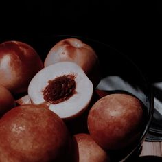 some apples are sitting in a bowl on the table