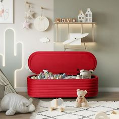 a toy chest in the corner of a child's room with toys on the floor