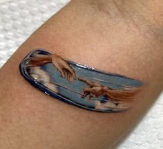 an artistic tattoo on the arm of a person