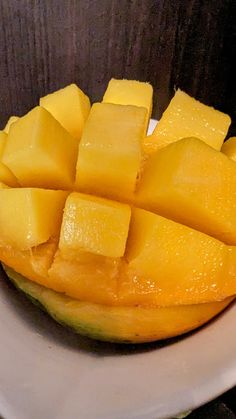 a white plate topped with cut up mangoes