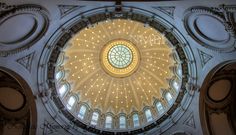 the inside of a building with a dome and lights on it's ceiling is shown